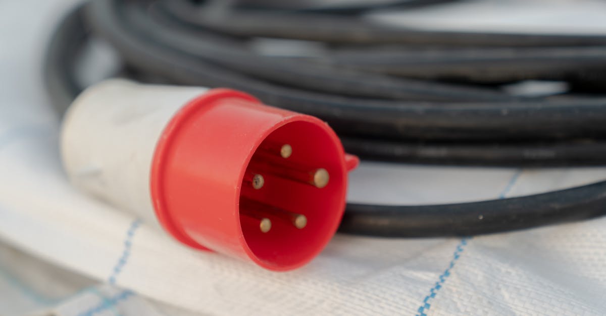 detailed view of a red industrial electrical cable plug with visible pins